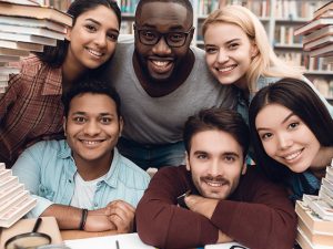 Diverse students sitting in library