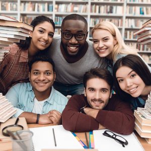 Diverse students sitting in library